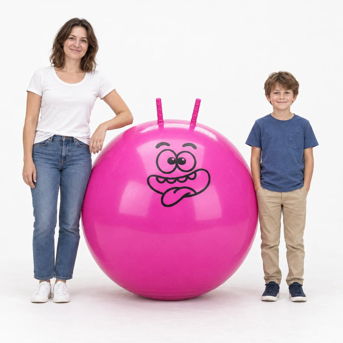 A woman and a boy standing next to a pink Hoppi hopper ball, 39 in (100 cm), to show its size