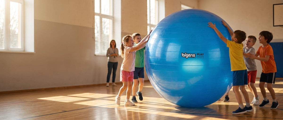 Kids pushing a giant blue Bigens Play Ball across a sunny school gym